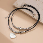 Multilayer schwarze Lederkette im Gothic Style – Wachsfaden Halskette mit Herz-Pailletten Anhänger für Damen, trendiger Party-Schmuck